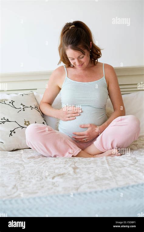 Smiling Pregnant Woman Sitting On Bed Stock Photo Alamy
