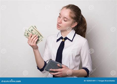portrait of a girl holding money dollars caucasian girl holding a wallet with money stock image