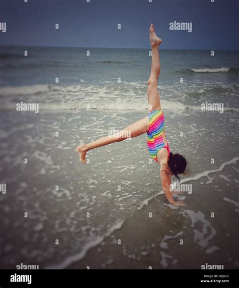 Gymnast Practicing Handstands At The Beach In The Water Stock Photo Alamy