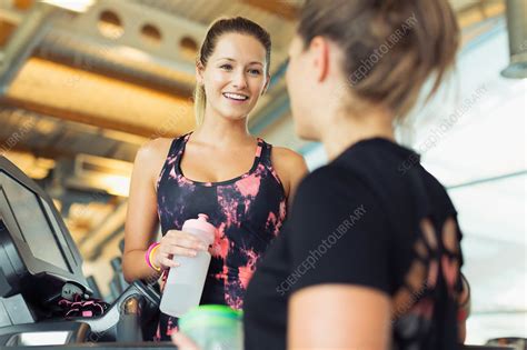 Women Talking And Drinking Water At Gym Stock Image