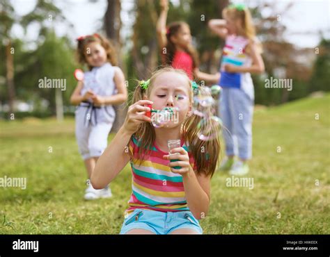 Blowing Bubbles In Park Stock Photo Alamy