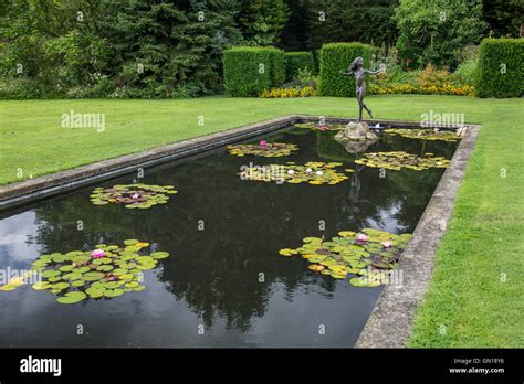 The Colourful Water Lily Pond With A Statue Of Young Girl At Waterperry