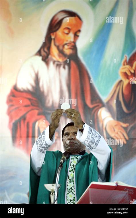 Roman Catholic Priest Consecrating The Host Papua New Guinea Stock