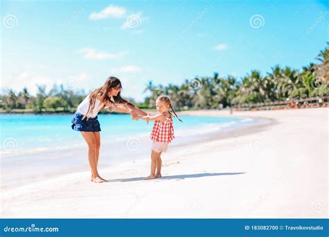 Beautiful Mother And Daughter On The Beach Enjoying Summer Vacation
