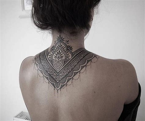 Ornamental Style Tattoo Covering Back Of The Neck And Upper Backdone