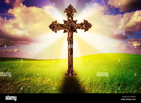 Beautiful Image Of A Cross In A Grass Field With A Holy Cloudy Sky