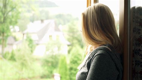 Pensive Woman Looking Through Window At The Country Stock Video Footage