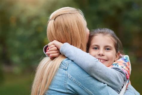 Girl Hugging Her Mother Stock Photo By ©mavoimages 137210294