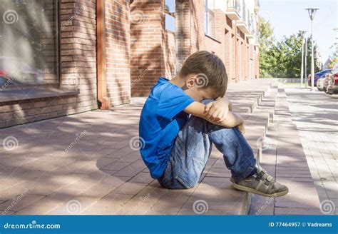 Sad Lonely Unhappy Disappointed Child Sitting Alone On The Ground