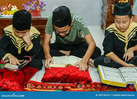Malaysian Muslim Kids Reading The Book Of The Holy Quran To Celebrate