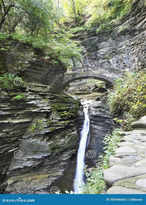 The Waterfall Running Under The Stone Bridge In Watkins Glen Gorge Or