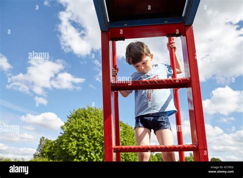 Boy Climbing Metal Ladder Stock Photo Alamy