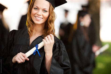 Graduation Pretty Graduate Holding Diploma By Stocksy Contributor