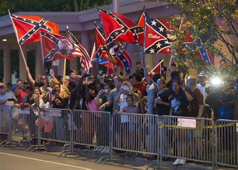 protesters wave confederate flags as first black president drives by in a motorcade vox
