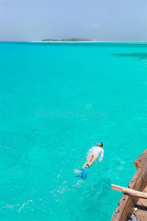 Woman Snorkeling In Clear Shallow Sea Of Tropical Lagoon With Turquoise
