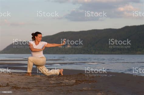 Woman Praticing Tai Chi Chuan At Sunset On The Beach Chinese Management