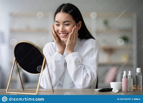 pretty asian woman in bathrobe making face lifting massage stock image image of beauty bottle