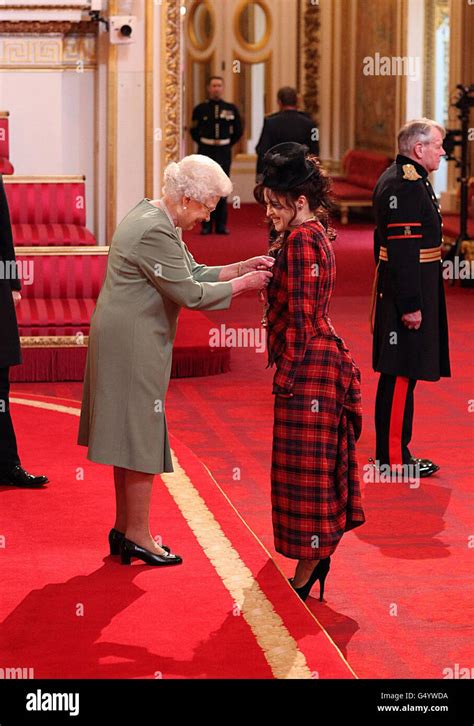 Queen Elizabeth Ii Presents Helena Bonham Carter With Her Commander Of The British Empire Cbe
