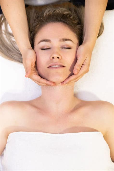 Young Blond Woman Receiving A Head Massage In A Spa Center Stock Image