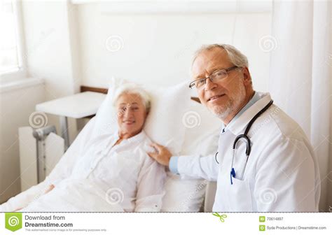 Doctor Visiting Senior Woman At Hospital Ward Stock Image Image Of