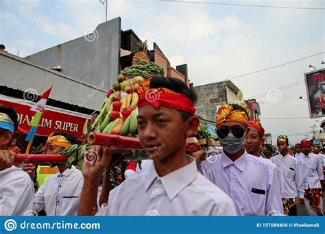 Balinese Men In Traditional Dress Bringing Offerings To