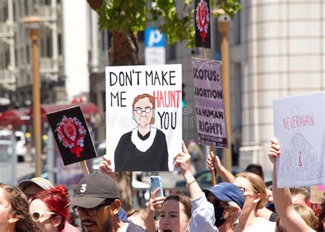 protestors holding signs marching in san francisco at womenâ€™s rights protest after scotus leak