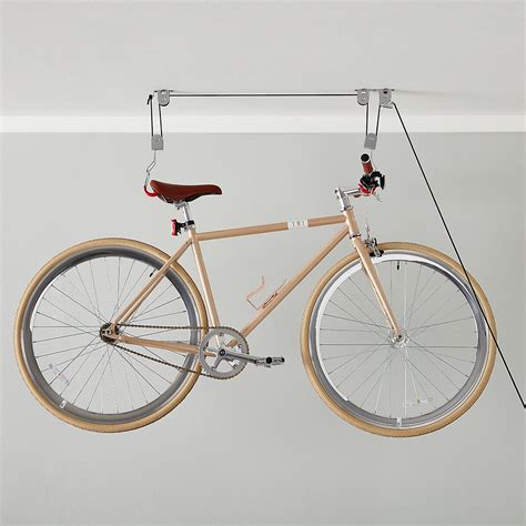 Simply load your bike, give it a slight push, and its gas and hydraulic spring system will raise it into its horizontal position. Ceiling-Mount Bike Lift | The Container Store