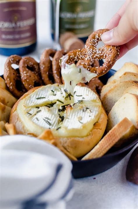 In this recipe the brie is topped with raspberry jam, surrounded with puff pastry and drizzled with maple syrup. Rosemary Garlic Baked Brie for Two | A Cookie Named Desire