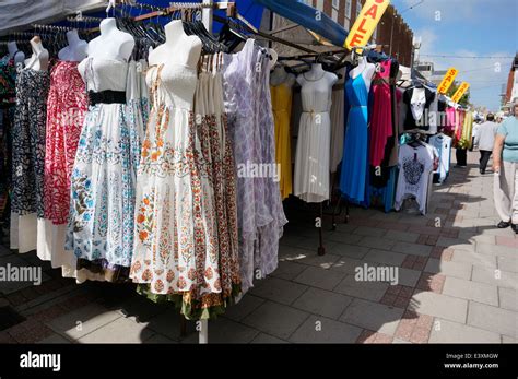 a market stall selling a selection of clothes dresses and cardigans in worthing precinct