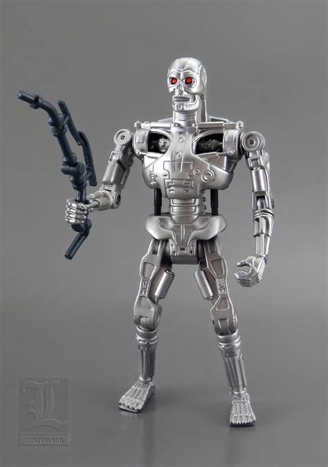 A Silver Robot Holding A Black Object In His Hand