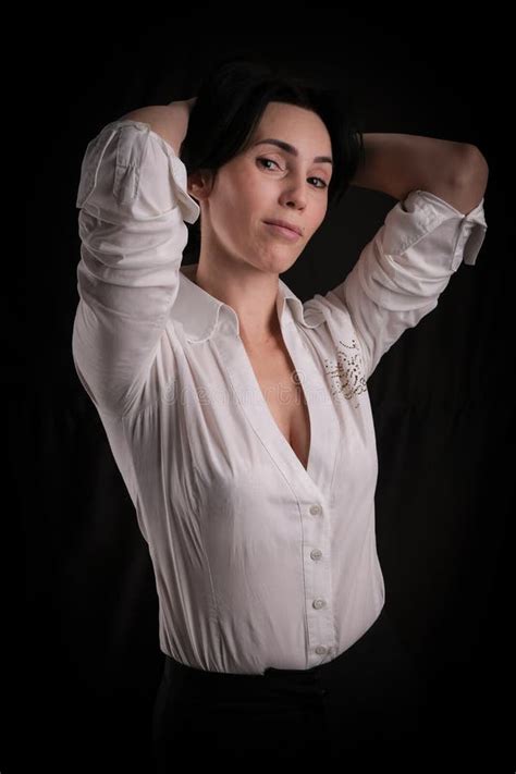 Portrait Of Beautiful Mature Brunette Woman Dressed In White Shirt Isolated On Black Background