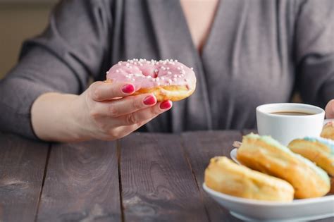 Premium Photo Woman Eat Donut And Drink Coffee