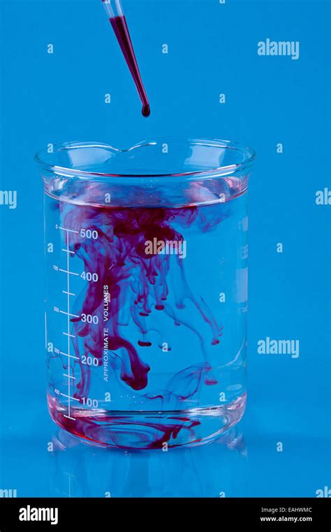 Red Food Coloring Dropped Into A Beaker Of Water Stock Photo Alamy