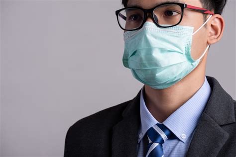Premium Photo Businessman In A Suit Wearing Protective Face Mask