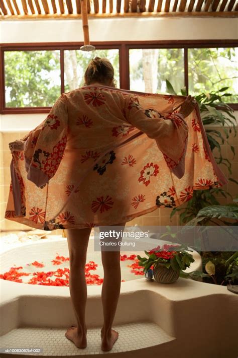 Woman Removing Bathrobe For Bath Photo Getty Images