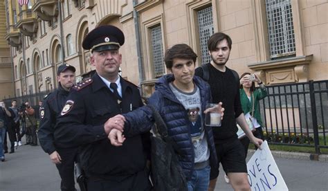 A Russian Police Officer Detains A Gay Rights Activist As He Tries To Show A Poster Reading
