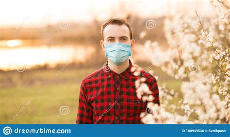 Portrait Of Young Man Wearing Face Mask Protecting From Air Pollution