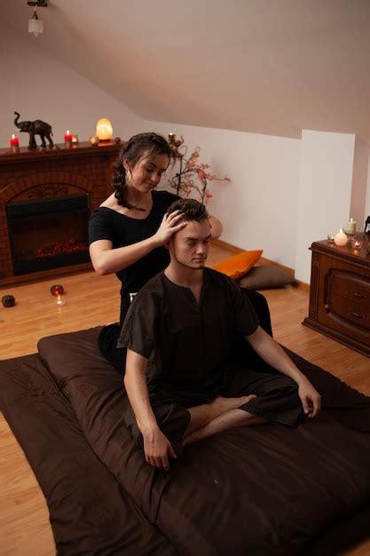 Premium Photo A Woman Getting A Mans Head Massage In A Room With A Fireplace And A Fireplace