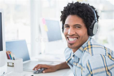Young Designer Listening To Music As He Works Stock Image Image Of