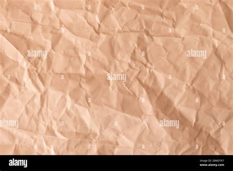 Texture Of A Crumpled Paper In Light Orange Color Empty Background