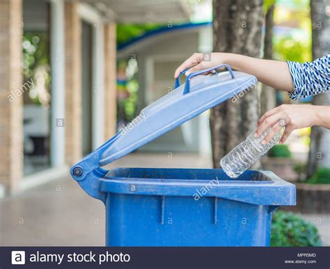 Closeup Portrait Woman Hand Throwing Empty Plastic Water Bottle In Recycling Bin Stock Photo Alamy