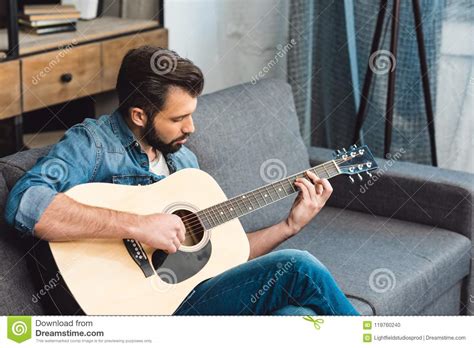 Handsome Young Man Playing Guitar While Sitting Stock Photo Image Of