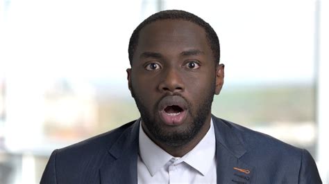 Portrait Of Shocked African American In Suit Amazed And Surprised