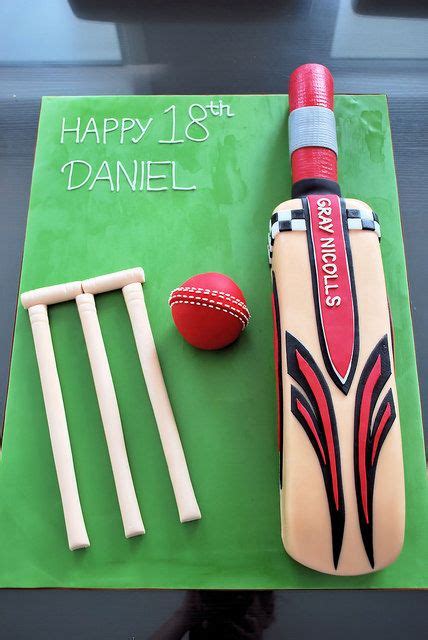 A Cake Made To Look Like A Cricket Bat And Ball