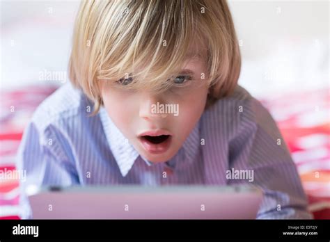 7 Year Old Boy Using Tablet Computer Stock Photo Alamy