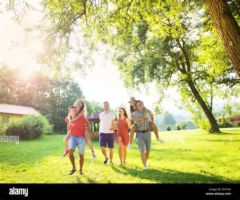 Group Of Five Teenage Friends Having Fun In Park Stock Photo Alamy