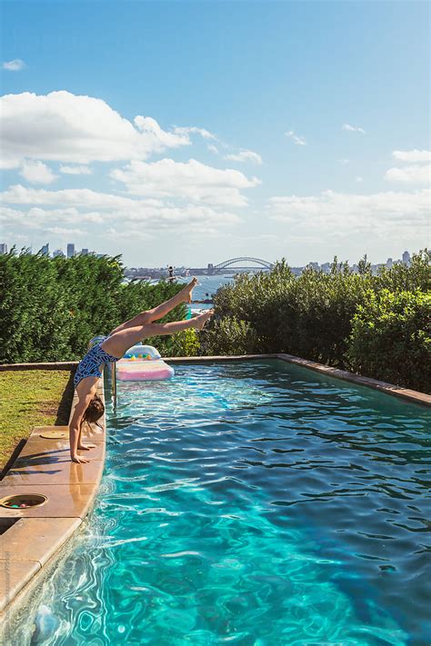 Girl Doing A Handstand Into A Backyard Pool In Sydney By Stocksy Contributor Gillian Vann