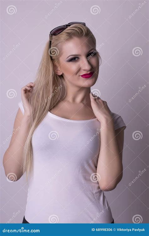 Lovely Woman In A White Shirt Over A Grey Background Stock Photo