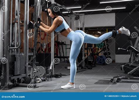 Fitness Woman Doing Exercise For Glutes Cable Kickbacks Athletic Girl Workout At The Gym Stock