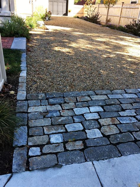 Driveway With Cobblestone Edging And Border And A Granite Entrance